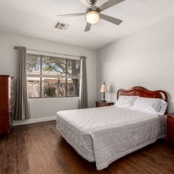 Mocean Flooring - Karndean Flooring is luxury vinyl with warm mid-brown tone and rustic knot details in the bedroom.