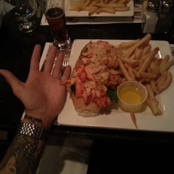 Marchetti's Restaurant - Hand for comparison of size! Baked stuffed lobster roll! - Italian Near Me - Cranston, Rhode Island