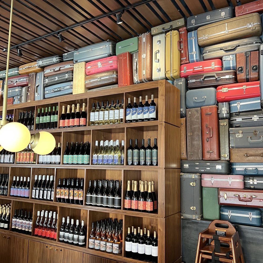 Postino Uptown Park - Luggage theme wall - Wine Bars Near Me - Houston, Texas Postino Uptown Park - Luggage theme wall - Wine Bars Near Me - Houston, Texas