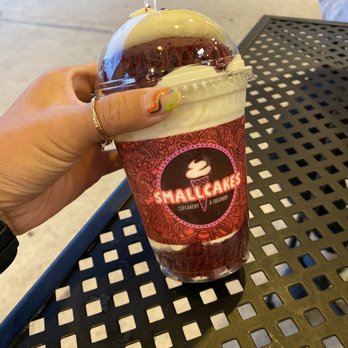 Smallcakes - a hand holding a cup of coffee - Desserts Near Me - Monroe, Louisiana