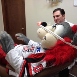 Bryant Dental - Dr. Noel giving Chaos, Huntsville Havoc, laughing gas to calm his nerves before his dental implant