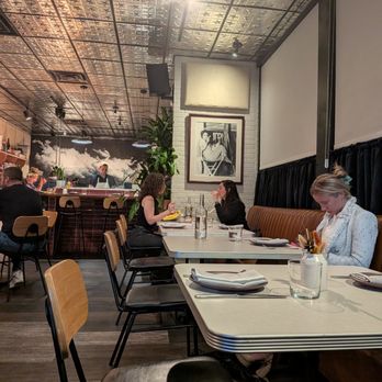 Walrus Rodeo - Inside. Dining room (banquette seating side) and open kitchen with wood-fire oven. - Italian Near Me - Miami, Florida Walrus Rodeo - Inside. Dining room (banquette seating side) and open kitchen with wood-fire oven. - Italian Near Me - Miami, Florida