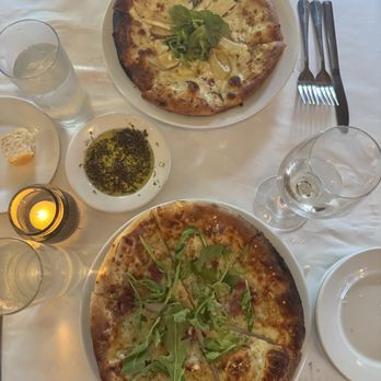 Figlio - Brie pizza on top and five cheese with arugula on bottom - Italian Near Me - Columbus, Ohio Figlio - Brie pizza on top and five cheese with arugula on bottom - Italian Near Me - Columbus, Ohio