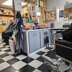 Vinton's Professional Hairstyling & Barber - One empty barber chair and the back chair where the lady hair stylist works from.