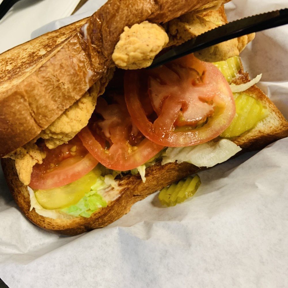 JLB Eatery - Pork chop sandwich with extra tomato and pickle. - Burgers Near Me - Tomball, Texas