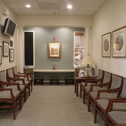 Zenaida Cofie, DDS MS PA - Waiting Room with LCD Flat Screen TV, magazine rack, and play area for kids.