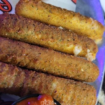 P-Dubs Brew Pub - Fried mozzarella sticks with a side of marinara sauce and onion rings, served on a metal tray at a restaurant. - Pubs Near Me - Tehachapi, California