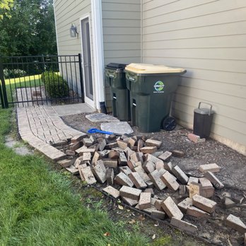 White Pine Landscaping - a pile of wood next to a trash can - Landscaping Near Me