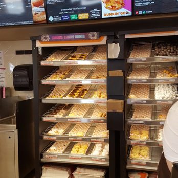 Dunkin' - a man standing in front of a display of donuts - Donuts Near Me - Branson, Missouri Dunkin' - a man standing in front of a display of donuts - Donuts Near Me - Branson, Missouri