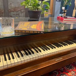 Have a drink, play piano, bone up on some triv