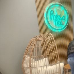 a woman sitting on a chair in a living room a woman sitting on a chair in a living room