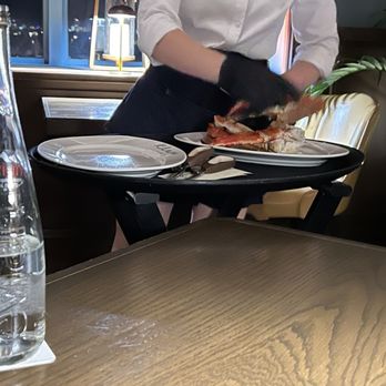 Klaw Miami - Our wonderful server cutting our crab legs for us. - Steakhouses Near Me - Miami, Florida