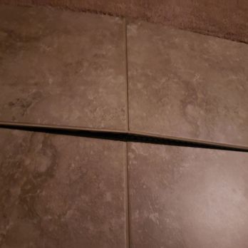 Delta Bay Home Inspections - Tile popped up on its own a few weeks after moving in. - Home Inspectors Near Me Delta Bay Home Inspections - Tile popped up on its own a few weeks after moving in. - Home Inspectors Near Me