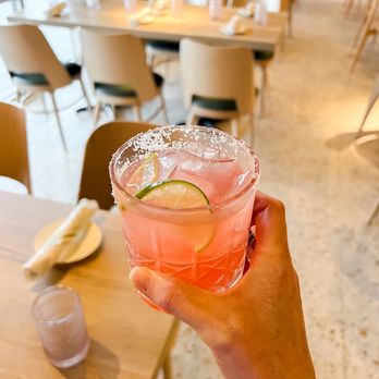 Pesca Vilano - a person holding a cocktail in a restaurant - Seafood Near Me - St. Augustine, Florida
