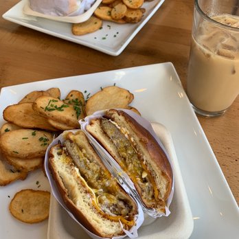 Eggspresso - Sausage, egg, and cheese sandwich with a side of potatoes and an iced caramel latte - Breakfast & Brunch Near Me - Petaluma, California