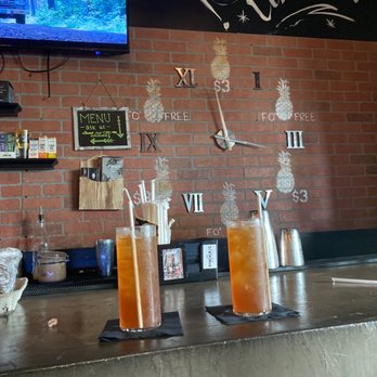 Syndicate Wynwood - Two Gold Kratum teas on-tap and their happy hour clock in the background! - Coffee & Tea Near Me - Miami, Florida