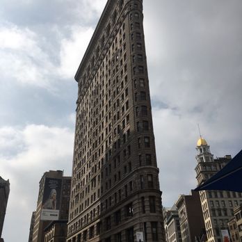Flatiron Building - Building while across the seating area - Landmarks & Historical Buildings Near Me - New York, New York Flatiron Building - Building while across the seating area - Landmarks & Historical Buildings Near Me - New York, New York