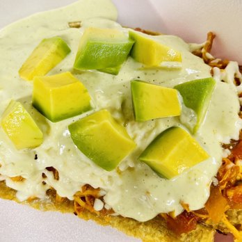 Rincon Montañero - a slice of nachos topped with cheese and avocado - Empanadas Near Me - Palm Harbor, Florida Rincon Montañero - a slice of nachos topped with cheese and avocado - Empanadas Near Me - Palm Harbor, Florida