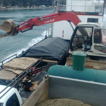 Orcas Excavators - We all enjoy this one. The barge was unbalanced so the excavator arm was moved to counterbalance the weight of the rock. - General Contractors Near Me - Eastsound, Washington Orcas Excavators - We all enjoy this one. The barge was unbalanced so the excavator arm was moved to counterbalance the weight of the rock. - General Contractors Near Me - Eastsound, Washington