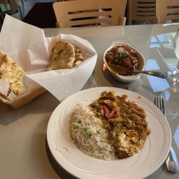 Garlic Naan, Chicken Jalfreezi, served on a bed of rice.