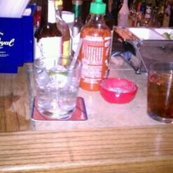 Lakeside Tavern - a bar counter with alcohol and condiments - American Near Me - Waco, Texas Lakeside Tavern - a bar counter with alcohol and condiments - American Near Me - Waco, Texas