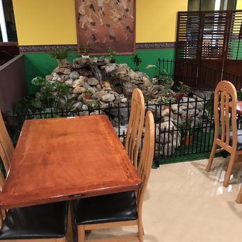 Daw Kun Thai - a table and chairs in a restaurant - Thai Near Me - Manchester, New Hampshire