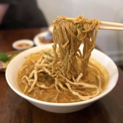 Mama Mu's Bistro - Chiang Mai (Khao Soi): Thai curry noodles w/ slow braised beef rib, crispy noodles, house pickle, red onion | $18
