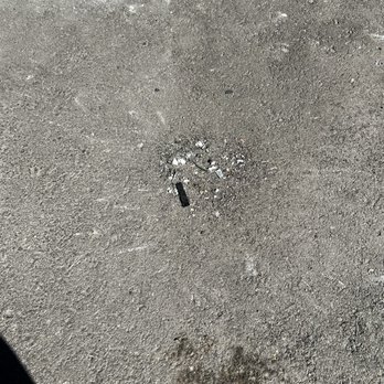 Elysium Reno - A pile of debris left by maintenance on the parking lot surface. - Apartments Near Me - Reno, Nevada