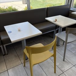 More food trash and liquid on tables all tables in restaurants look like they haven't been wiped clean also