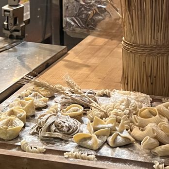 Aqua Pazza - a wooden cutting board with raw pastas on it - Italian Near Me - Boston, Massachusetts