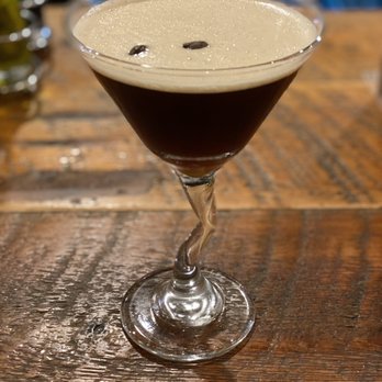 Parisi - a glass of coffee on a wooden table - Italian Near Me - Denver, Colorado Parisi - a glass of coffee on a wooden table - Italian Near Me - Denver, Colorado