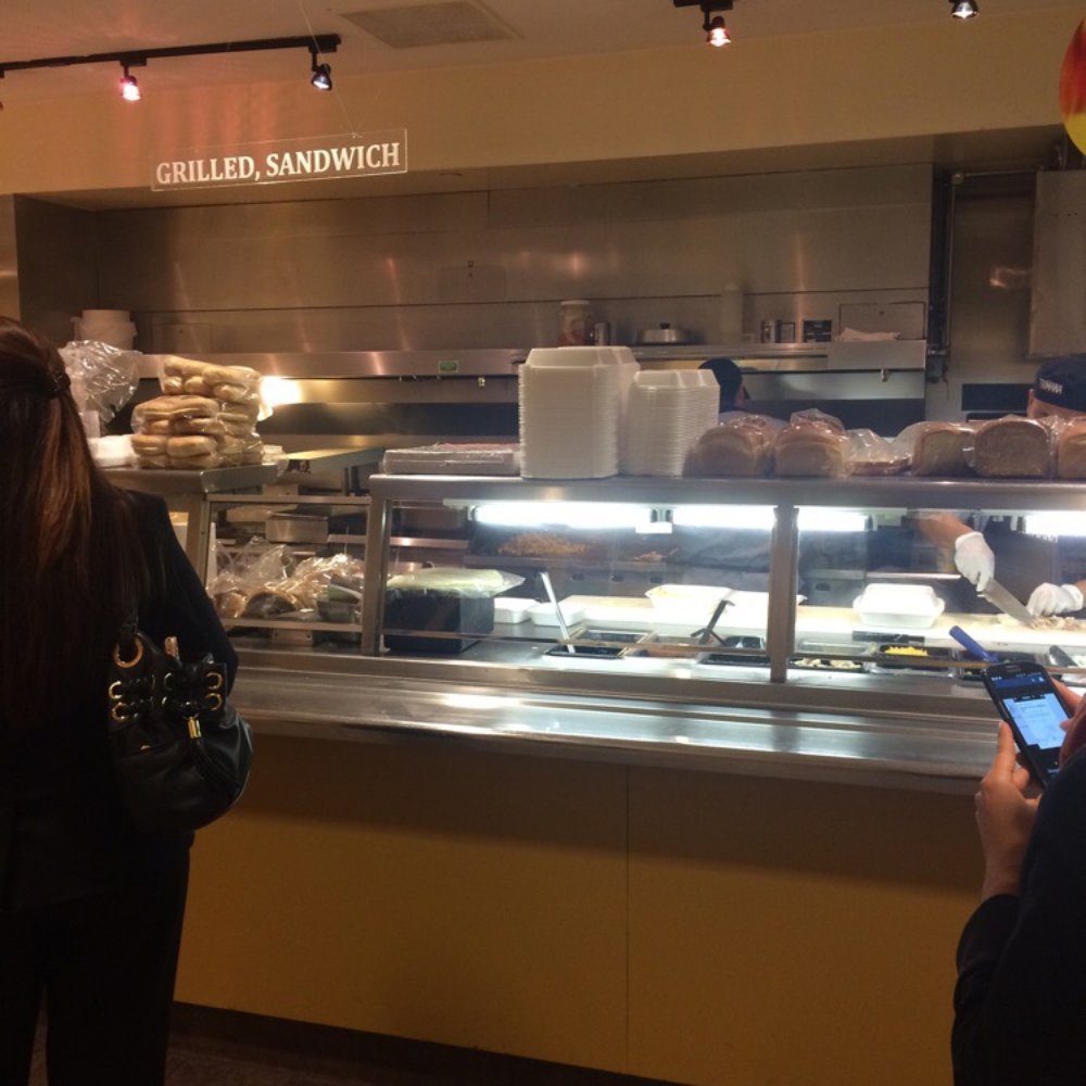 Trimana - two people standing in front of a deli counter - New American Near Me - Los Angeles, California Trimana - two people standing in front of a deli counter - New American Near Me - Los Angeles, California