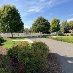 Southern Oregon RV Park - Each site is paved with a small grass area and cement dinning area for the picnic tables