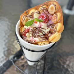Crave Cafe - Bubble Waffle with Vanilla Bean ice cream with Raspberries and Bananas along with Nutella