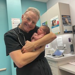 Hopkins Eric, MD - Dr. Hopkins holding baby Luca