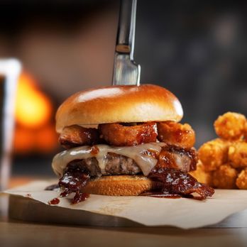 WSKY Bar + Grill - a pulled pork sandwich with barbecue sauce and onion rings - Bars Near Me - Las Vegas, Nevada WSKY Bar + Grill - a pulled pork sandwich with barbecue sauce and onion rings - Bars Near Me - Las Vegas, Nevada