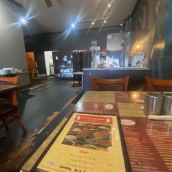 Naan Pizza - Interior. The booth seating was missing a spring. I was shocked (not in a good way) when I sat down.