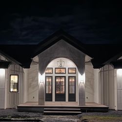 Luxury Lighting and Design - Exterior Elco can lights with wall sconces to highlight your home.