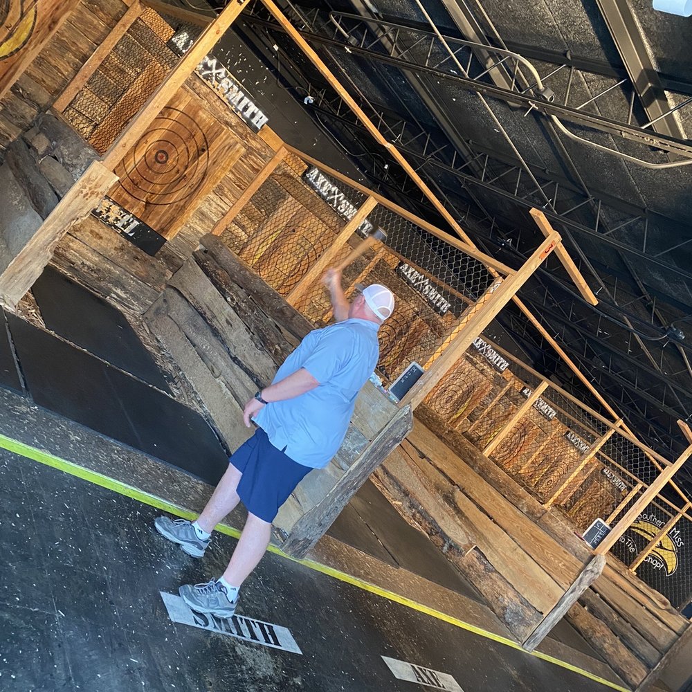 AxeSmith - a man on a skateboard in a warehouse - Axe Throwing Near Me - Hattiesburg, Mississippi AxeSmith - a man on a skateboard in a warehouse - Axe Throwing Near Me - Hattiesburg, Mississippi