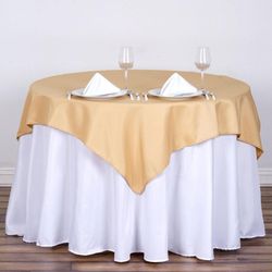 The Rental Shop - 48" Round Table with White Tablecloth, Gold Overlay, Silver Charger, and White Napkins