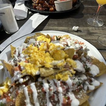 Baja Cantina - Top : Chorizo Benedict and $15 Bottle Mimosa Service  Bottom: Volacano Chilaquiles - Mexican Near Me - The Woodlands, Texas