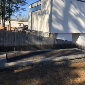 Southern Classic Landscape Management - a backyard with a raised concrete patio - Landscaping Near Me - Buford, Georgia Southern Classic Landscape Management - a backyard with a raised concrete patio - Landscaping Near Me - Buford, Georgia