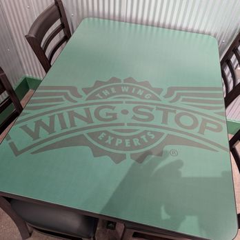 Wingstop - Our table. One of three tables in the restaurant. Each tabletop has a different look. - Chicken Wings Near Me - West Hollywood, California Wingstop - Our table. One of three tables in the restaurant. Each tabletop has a different look. - Chicken Wings Near Me - West Hollywood, California