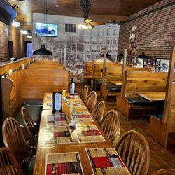 River House Bar and Grill - Some of 1st floor dining room area with wall pic of early Moline, comical window art