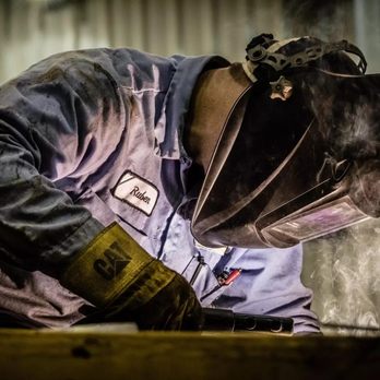Fabick Cat - a welder working on a piece of wood - Building Supplies Near Me - De Pere, Wisconsin Fabick Cat - a welder working on a piece of wood - Building Supplies Near Me - De Pere, Wisconsin