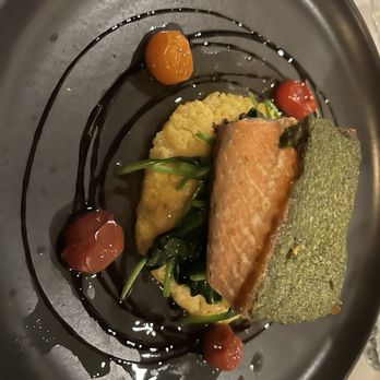 Forbes Mill Steakhouse - Pesto salmon with creamy polenta, sautéed spinach, heirloom tomatoes and balsamic glaze - Steakhouses Near Me - Los Gatos, California