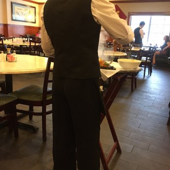 New Asia Restaurant - Sizzling Triple Harvest. Waitress preparing my order with her back to me to purposely prevent me from seeing her do it. - Chinese Near Me - Germantown, Tennessee