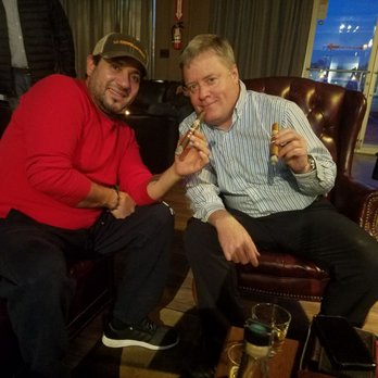 The Cave Cigar Lounge - two men enjoying a cigar - Cigar Bars Near Me - Newark, New Jersey The Cave Cigar Lounge - two men enjoying a cigar - Cigar Bars Near Me - Newark, New Jersey