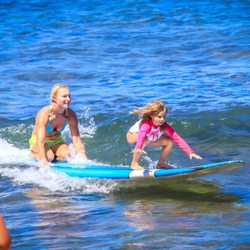 Mindbody Surf and Yoga School - Kyra age 6, tandem surfing with Instrutor Lindsay. Visiting from Newport Beach, CA