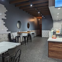 a dining area with tables and chairs a dining area with tables and chairs